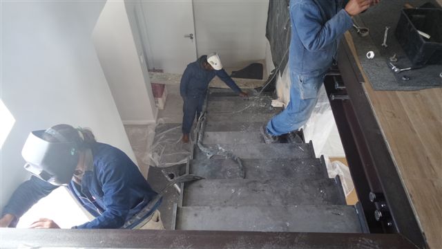 steel studio employees installing balustrades and staircases
